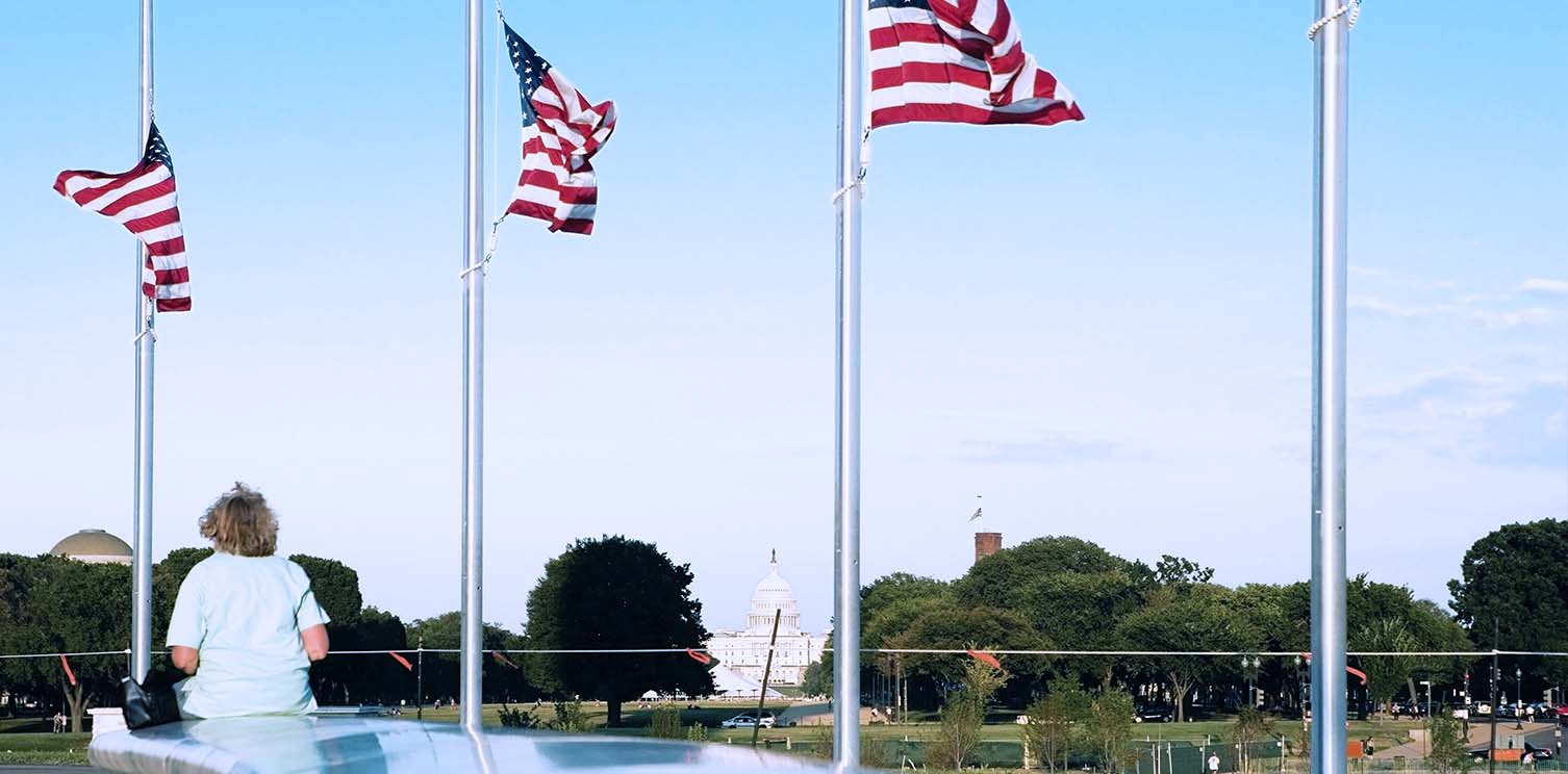 Three American flags at half-mast in Washington, DC