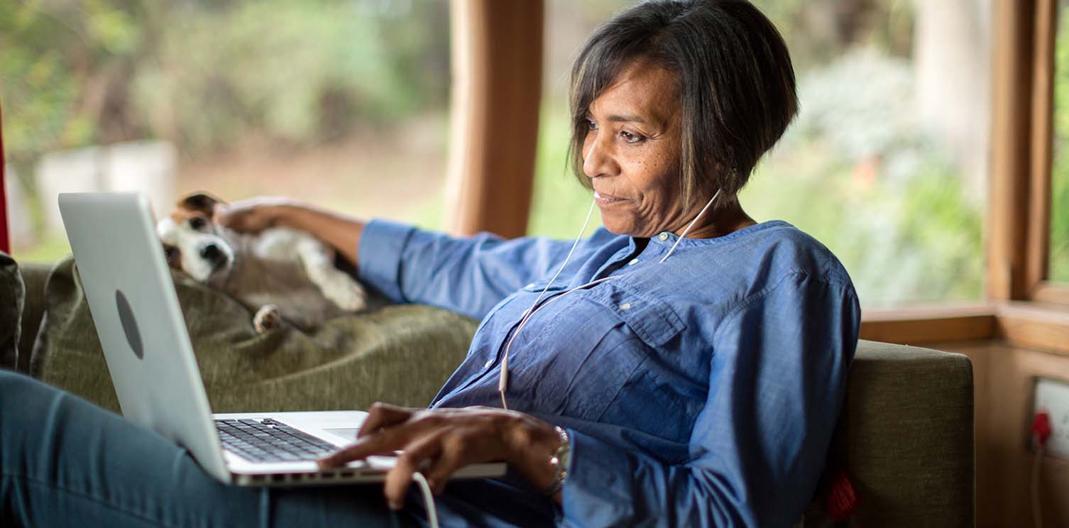 Black lady with bob haircut looking at her laptop